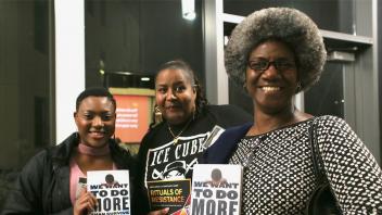 Attendees holding books from the Equity Summit book sale